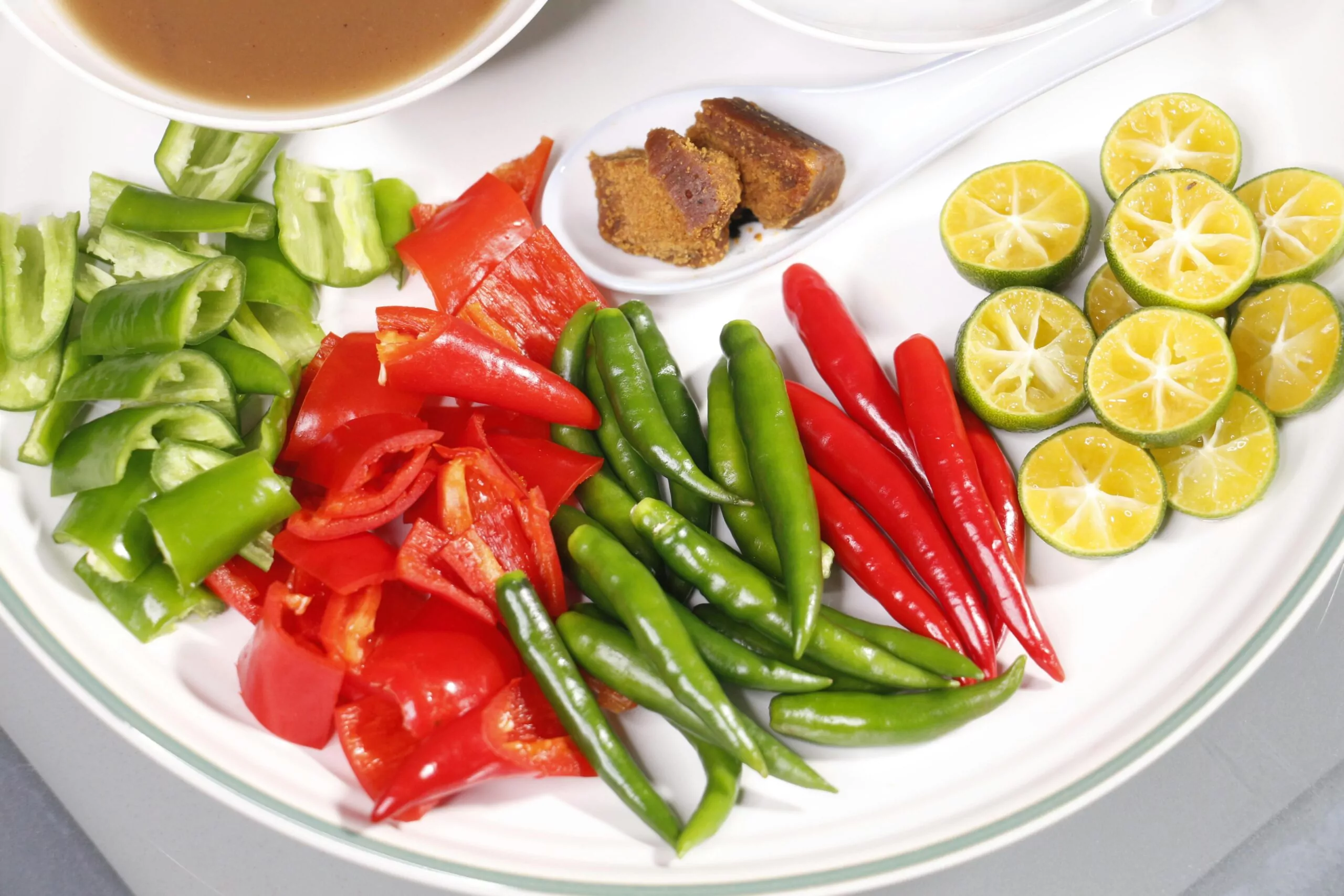 A colorful plate of metabolism-boosting foods including lean proteins, vegetables, and spices like ginger and cayenne pepper, representing healthy eating for women.