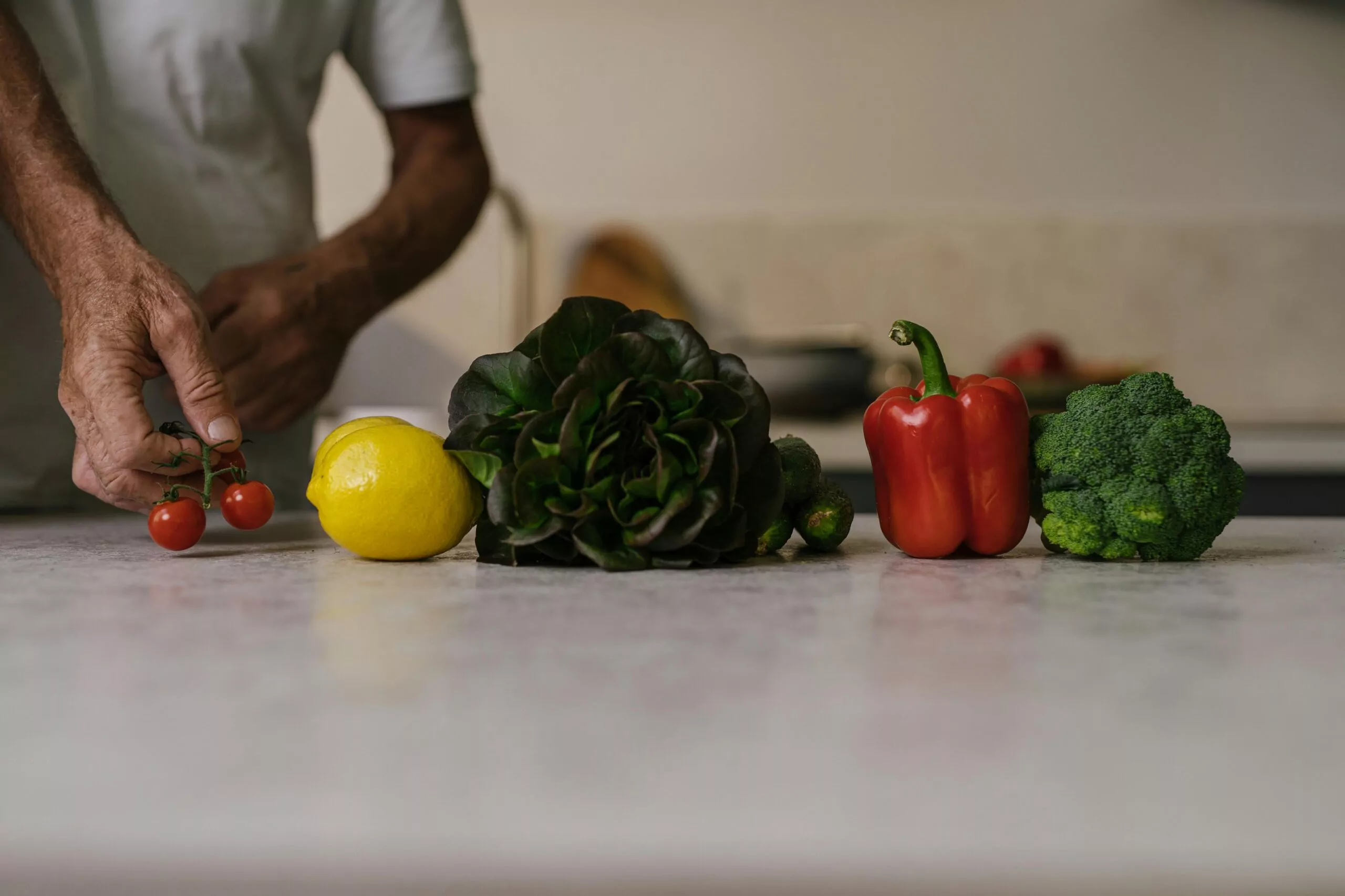 Colorful smoothie ingredients on a kitchen counter featuring fruits, greens, and nuts for a healthy smoothie diet.